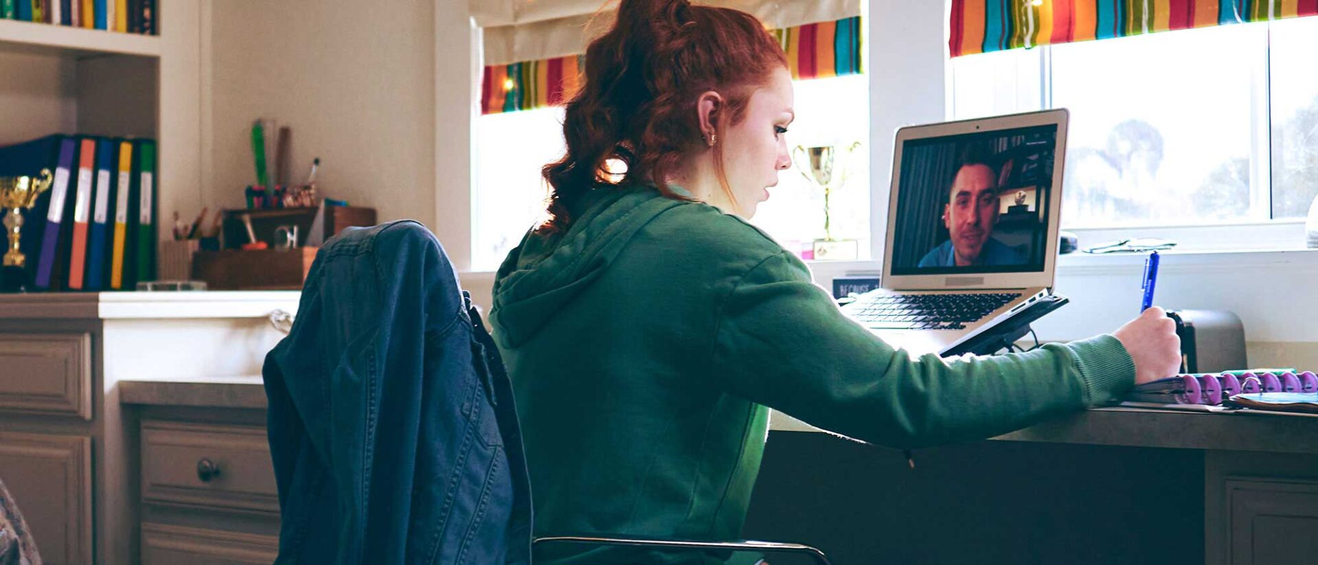 Student sitting at her desktop doing homework