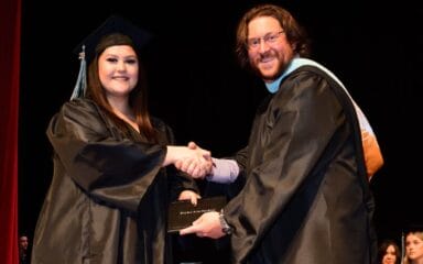 Graduated students shaking hands