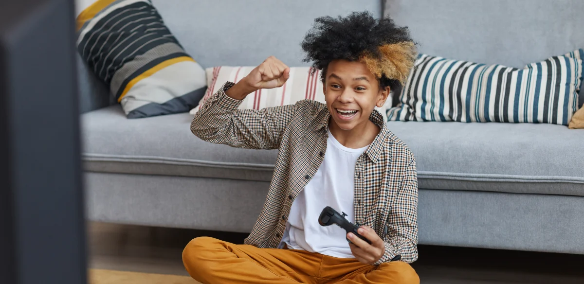 Student playing videogames at home