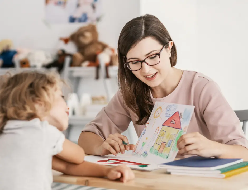 Education student with a child showing her a drawing