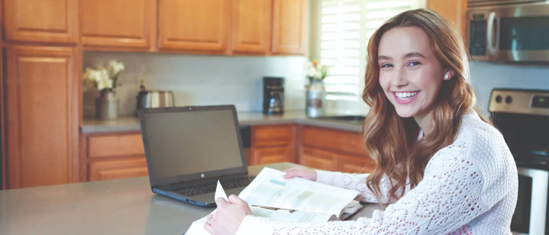 Student doing homework in her kitchen